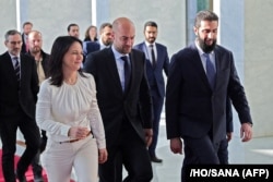 French Foreign Minister Jean-Noel Barrot and Germany's Annalena Baerbock walk with Sharaa ahead of their meeting in Damascus on January 3.