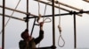 An Iranian soldier prepares a noose for a public hanging (file photo)