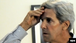 John Kerry was in Pakistan to urge officials to release a U.S. consular employee being held for killing two men. 